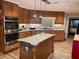 Spacious kitchen featuring granite countertops, stainless steel appliances, and a center island at 828 Cedar Stream Ct, Loganville, GA 30052