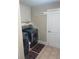 Functional laundry room with cabinetry above washer dryer and decorative rug on tiled floor at 828 Cedar Stream Ct, Loganville, GA 30052