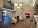 Bright living room with hardwood floors, high ceilings, and a fireplace, open to dining room at 828 Cedar Stream Ct, Loganville, GA 30052