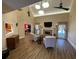 Bright living room with hardwood floors, high ceilings, and a fireplace, open to dining room at 828 Cedar Stream Ct, Loganville, GA 30052