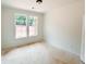 Bright bedroom featuring a large window with natural light and fresh, white walls at 1239 Pj East Rd, Covington, GA 30014