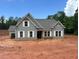 Charming single-Gathering home featuring light gray siding, a gray roof, white trim, and a brick foundation at 1239 Pj East Rd, Covington, GA 30014