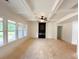 Spacious living room with coffered ceilings, fireplace and large windows offering plenty of natural light at 1239 Pj East Rd, Covington, GA 30014
