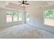 Main bedroom with a tray ceiling, ceiling fan, and natural light at 1239 Pj East Rd, Covington, GA 30014
