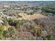 An aerial view of the property highlighting its expansive land, serene lake, and potential for various activities at 1401 Rainey Rd, Temple, GA 30179