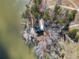 A high angle view of the property with waterfront location, wooded area, and a private dock at 1401 Rainey Rd, Temple, GA 30179
