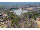 Aerial view of lakefront land with surrounding trees, showcasing the natural beauty and privacy of the property at 1401 Rainey Rd, Temple, GA 30179