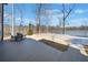 A view from the back deck with an outdoor dining table overlooking the water at 1401 Rainey Rd, Temple, GA 30179