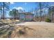 Expansive backyard featuring a meticulously maintained lawn, mature trees, and an elegant two-story home at 1401 Rainey Rd, Temple, GA 30179