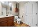 Cozy bathroom with hardwood floors, single vanity, toilet and shower at 1401 Rainey Rd, Temple, GA 30179