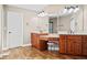 Bright bathroom with double vanity, granite countertop, cherry cabinets and a makeup area at 1401 Rainey Rd, Temple, GA 30179