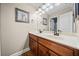 Bright bathroom featuring double vanity with granite countertops, cherry cabinets at 1401 Rainey Rd, Temple, GA 30179