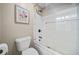 Cozy bathroom with a shower and sliding glass door, features stylish fixtures and floral wall art at 1401 Rainey Rd, Temple, GA 30179