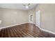 Spacious bedroom features beautiful wood floors, neutral paint, and a ceiling fan at 1401 Rainey Rd, Temple, GA 30179