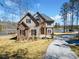 Charming home featuring stone and siding, a driveway, and beautiful lake views at 1401 Rainey Rd, Temple, GA 30179