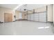 Well-lit garage with epoxy floor, garage door, EV charger and ample space at 1401 Rainey Rd, Temple, GA 30179