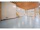 Expansive garage with high ceilings, exposed wood beams and ample space at 1401 Rainey Rd, Temple, GA 30179