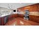 A gourmet kitchen featuring custom cabinets, granite counters, stainless steel appliances, and lake views at 1401 Rainey Rd, Temple, GA 30179