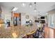 Open concept kitchen features an island with bar seating and stone countertops at 1401 Rainey Rd, Temple, GA 30179