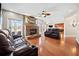 Spacious living room with stone fireplace, hardwood floors, and comfortable leather seating at 1401 Rainey Rd, Temple, GA 30179