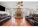 Living room boasts hardwood floors, stone fireplace, and comfortable seating at 1401 Rainey Rd, Temple, GA 30179