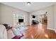 Spacious living room with hardwood floors, a fireplace, and large windows at 1401 Rainey Rd, Temple, GA 30179