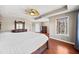 Main bedroom with tray ceiling, wooden furniture, and carpet at 1401 Rainey Rd, Temple, GA 30179