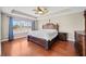 The main bedroom has a tray ceiling, fan, and large windows for great natural light at 1401 Rainey Rd, Temple, GA 30179