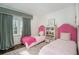 Charming bedroom features two twin beds with pink accents and a large window at 1225 W Wesley Nw Rd, Atlanta, GA 30327