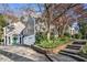 Home exterior with gray siding, stone steps, stone retaining wall, and an attached garage with a green door at 1225 W Wesley Nw Rd, Atlanta, GA 30327