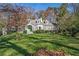 Charming home featuring a well-manicured front yard and a welcoming entrance with a vibrant green door at 1225 W Wesley Nw Rd, Atlanta, GA 30327