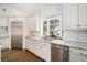 Modern kitchen featuring white cabinets, granite countertops, stainless steel appliances, and a bay window at 1225 W Wesley Nw Rd, Atlanta, GA 30327