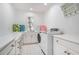 Well-lit laundry room with modern washer/dryer, built-in cabinets and folding counter at 1225 W Wesley Nw Rd, Atlanta, GA 30327