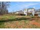 Spacious backyard with green grass and view of the home's exterior at 1370 Wheatfield Dr, Lawrenceville, GA 30043