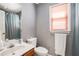 Bathroom with combined shower and tub and neutral color palette at 1370 Wheatfield Dr, Lawrenceville, GA 30043