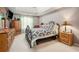 Bedroom with light-colored walls, soft carpet, and a patterned bedspread at 1370 Wheatfield Dr, Lawrenceville, GA 30043