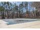 A community pool is covered for the off-season, ready for warmer days in a serene, wooded setting at 1370 Wheatfield Dr, Lawrenceville, GA 30043