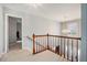 Bright open foyer with wood railing and chandelier lighting at 1370 Wheatfield Dr, Lawrenceville, GA 30043