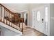 Inviting foyer with hardwood floors, a staircase, and a view into the formal dining room at 1370 Wheatfield Dr, Lawrenceville, GA 30043