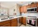 This spacious kitchen has wooden cabinets, stainless steel appliances and granite countertops at 1370 Wheatfield Dr, Lawrenceville, GA 30043