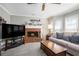 Cozy living room features a red brick fireplace and comfortable furnishings at 1370 Wheatfield Dr, Lawrenceville, GA 30043