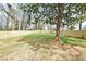 Large, fenced backyard with mature trees and green grass at 1650 Eastport Se Ter, Atlanta, GA 30317