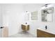 Modern bathroom with double vanity, wood cabinets, stone floors, and two framed mirrors at 1650 Eastport Se Ter, Atlanta, GA 30317