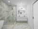 Bathroom featuring marble and gold fixtures, glass walk-in shower, and double vanity at 1650 Eastport Se Ter, Atlanta, GA 30317