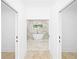 Hallway view of luxury bathroom with marble accents and standalone tub on raised platform at 1650 Eastport Se Ter, Atlanta, GA 30317