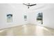 Bright bedroom featuring three windows, a tray ceiling and a modern ceiling fan at 1650 Eastport Se Ter, Atlanta, GA 30317