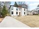 Contemporary white home with large windows and a concrete driveway enhancing curb appeal at 1650 Eastport Se Ter, Atlanta, GA 30317