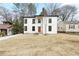 Modern home with a white exterior, dark trim, and a well-manicured lawn at 1650 Eastport Se Ter, Atlanta, GA 30317