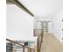 Hallway with wood floors, black railings, and view of the kitchen at 1650 Eastport Se Ter, Atlanta, GA 30317