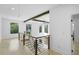 Hallway with railing, wood beam, and view to large windows at 1650 Eastport Se Ter, Atlanta, GA 30317